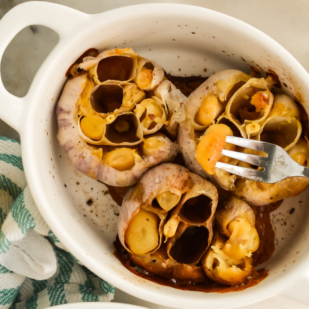 Roasted Garlic with Olive Oil in a baking dish.
