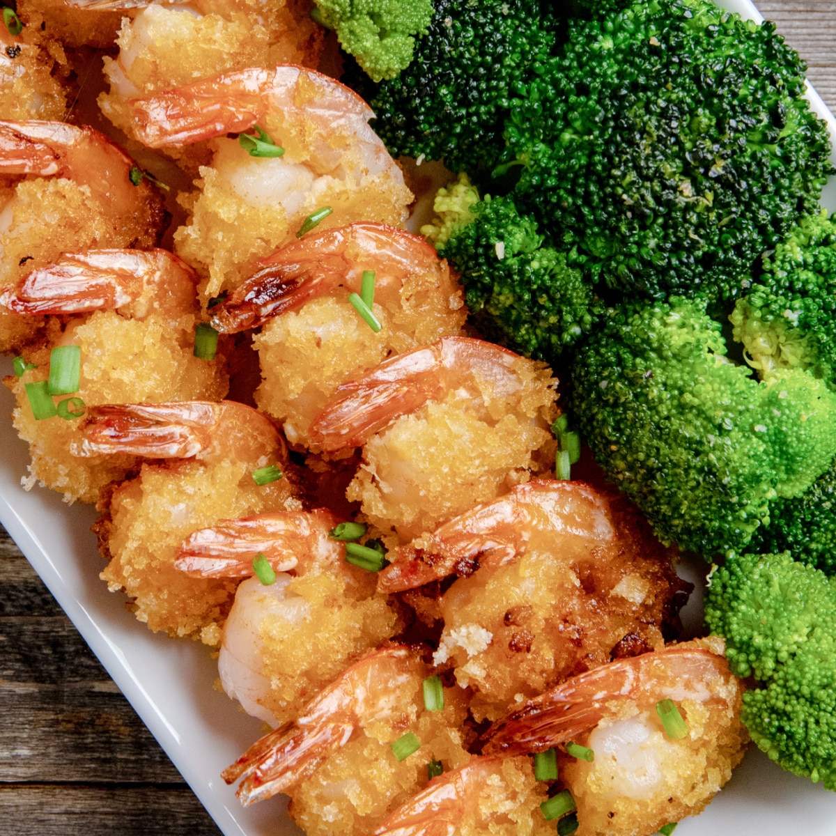Breaded Sriracha Shrimp on a platter with broccoli.
