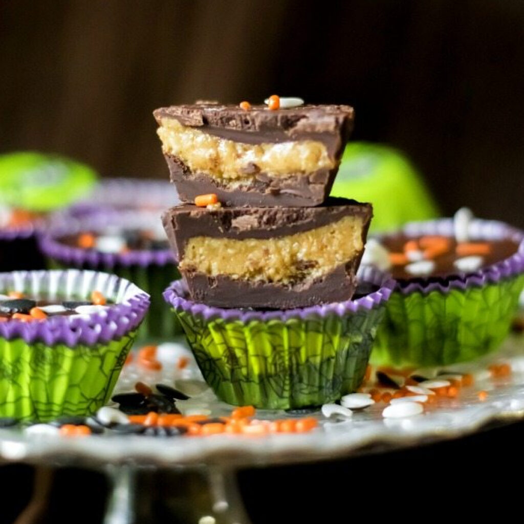 Homemade peanut butter cups for Halloween stacked on top of one another.