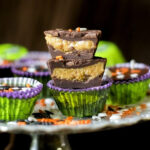 Homemade peanut butter cups for Halloween stacked on top of one another.