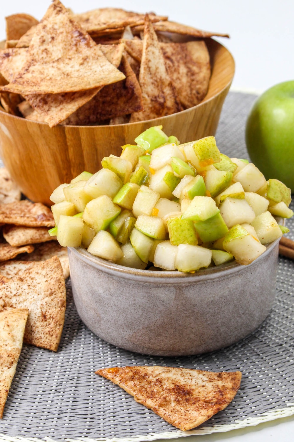Fresh Apple Salsa in a bowl beside cinnamon chips.
