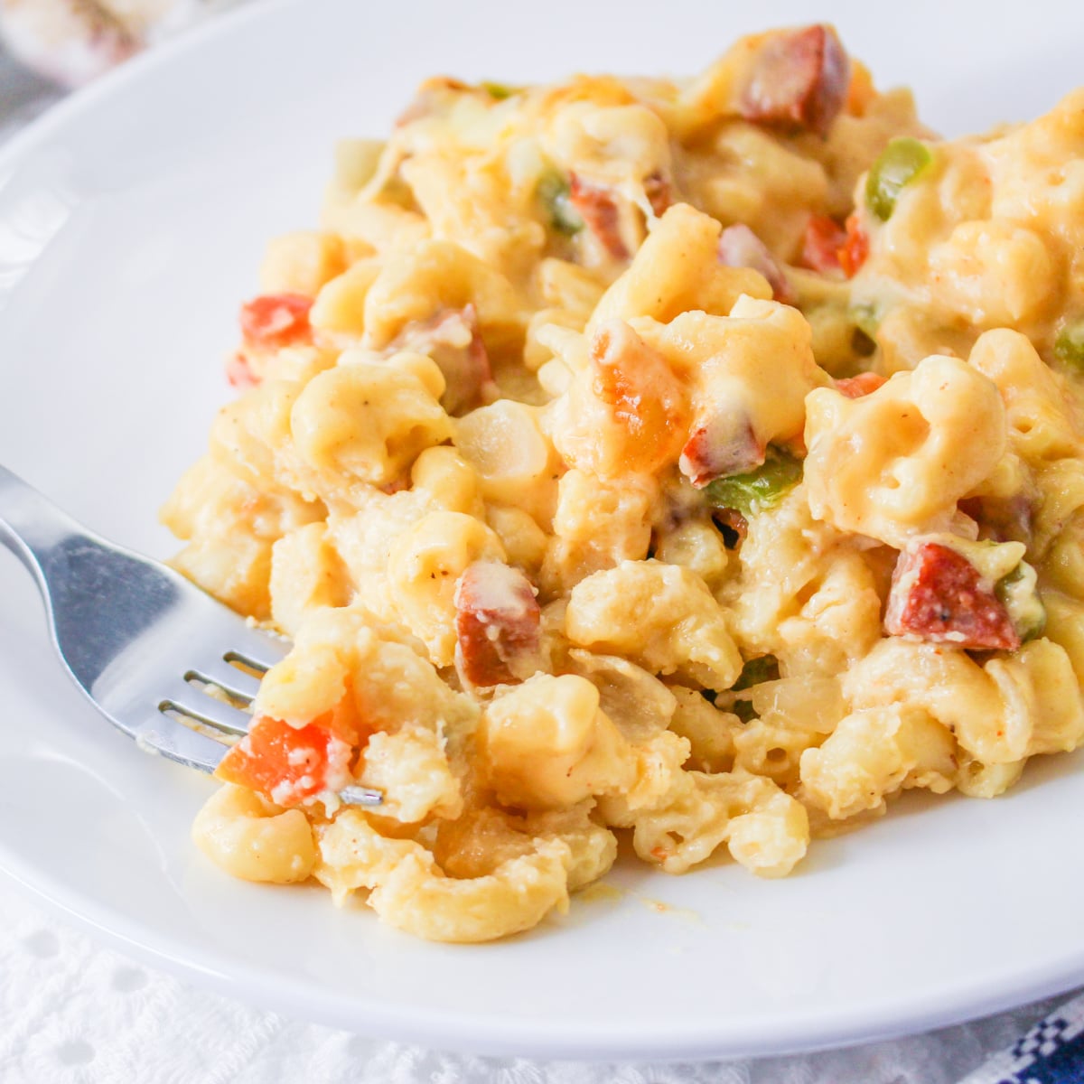 Cheesy Cajun Mac and Cheese on a plate with a fork.