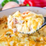 Spoonful of Cajun macaroni and cheese with sausage.