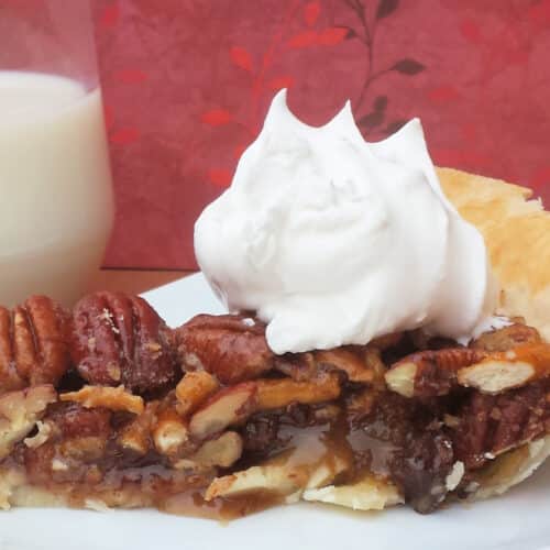Chocolate Pecan Pie with Pretzels topped with whipped cream.
