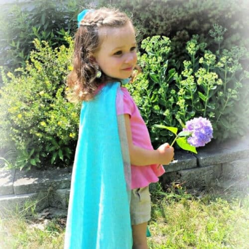 Little girl models DIY Elsa's Cape from Disney's Frozen.