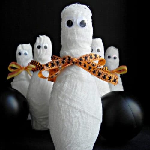 Halloween Mummy Bowling - bowling pins wrapped up like mummies with eyes.