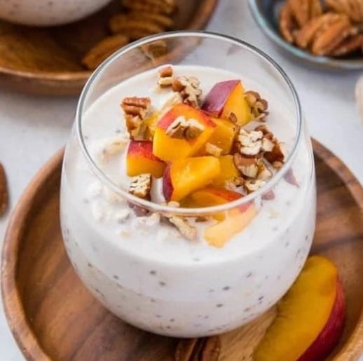 Close up of Peaches and Cream Overnight Oats in a glass.