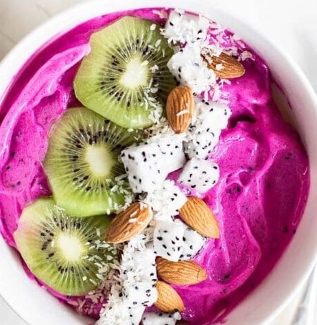 Dragon Fruit Smoothie Bowl with kiwi and almonds.