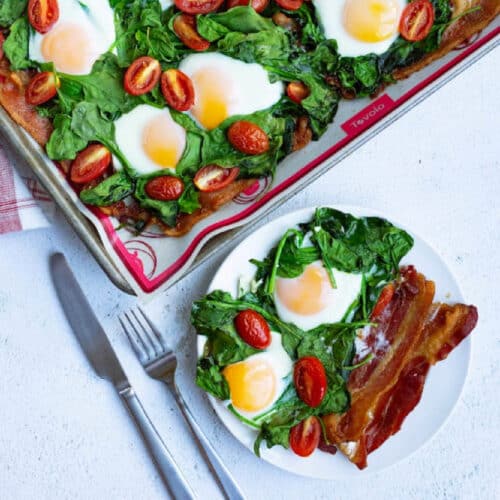 Sheet Pan Eggs and Bacon with spinach on a plate.