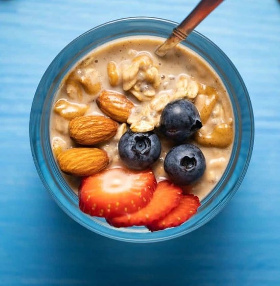 Vegan Overnight Oats with almond butter strawberries and blueberries.