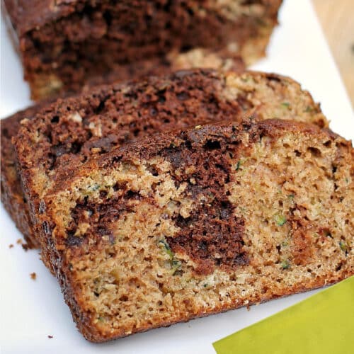 Close up of chocolate marble zucchini bread and a lime green napkin.
