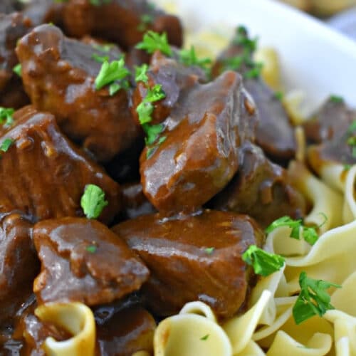 Close up of Beef Tips with Gravy and egg noodles.