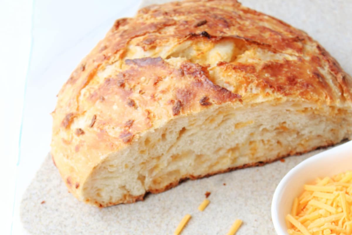 Loaf of cut Dutch Oven Cheese Bread.