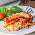 Lazy Lasagna with Ravioli on a plate with salad.