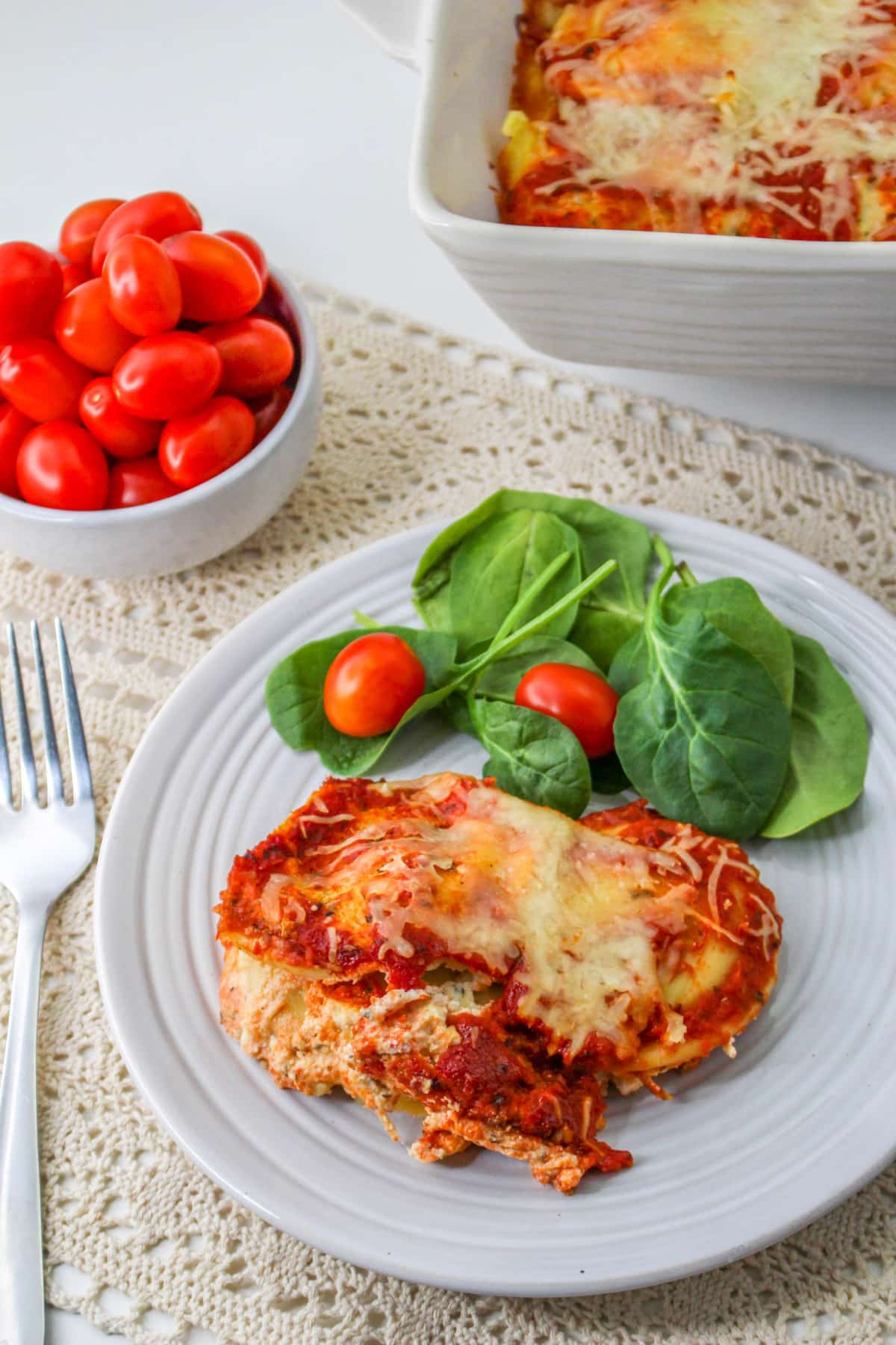 Ravioli Lasagna on a plate with salad.