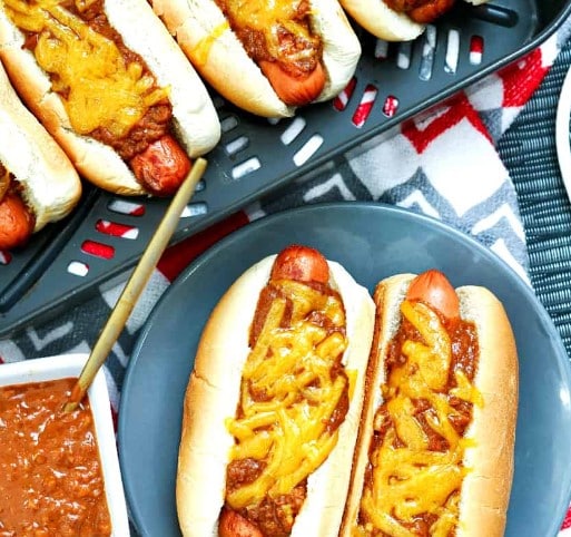 Top down view of chili cheese dogs.