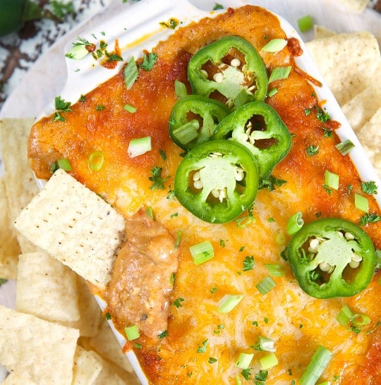 Easy Chili Cheese Dip tipped with slices of jalapeno pepper.