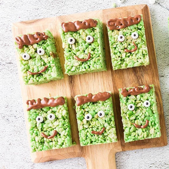 Frankenstein Rice Krispie Treats on a cutting board.