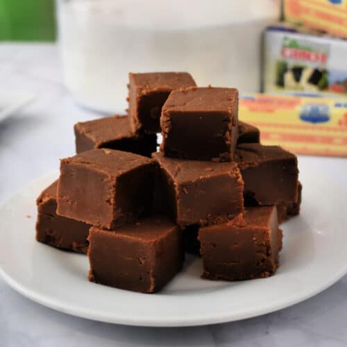 Old Fashioned Chocolate Peanut Butter Fudge stacked on a plate.