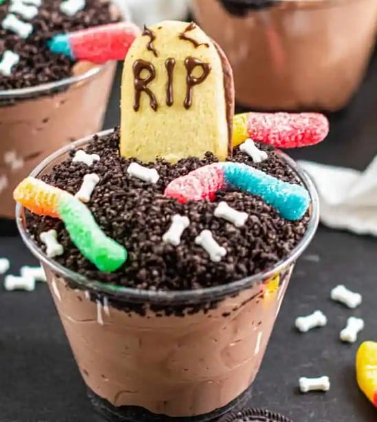 Spooky Graveyard Dirt Cups with a tombstone cookie.