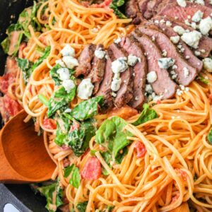 Close up of Steakhouse Pasta Dish with serving spoon.