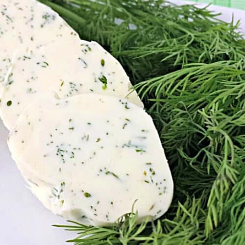 Slices of dill butter next to fresh dill.