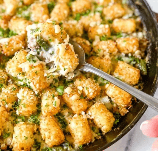 Cast iron skillet of tater tot turkey casserole.