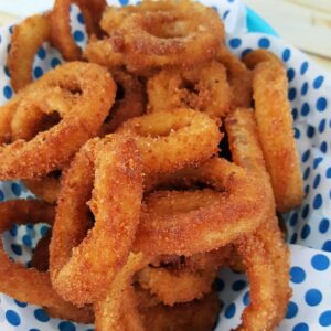 Close up of Panko onion rings in a basket.