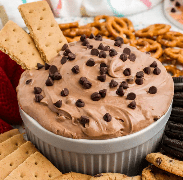 Bowl of brownie batter dip with chocolate chips and graham crackers.