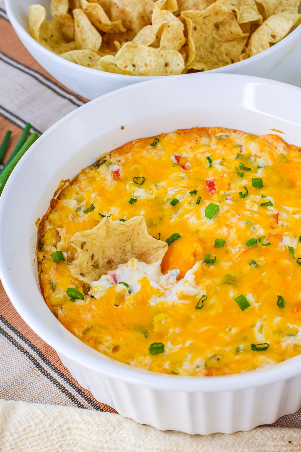 Bowl of hot corn dip with tortilla chips.