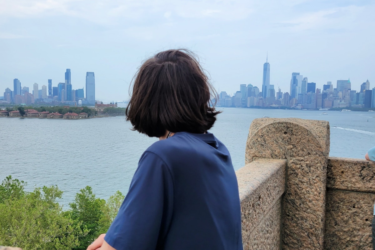 Tenn looks at Manhattan Skyline from Statue of Liberty pedestal.