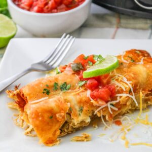 Close up of easy slow cooker chicken enchiladas on a plate.