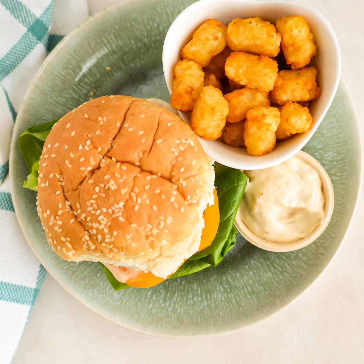 Top down view of burger and tater tots with a side of homemade Donkey Sauce.