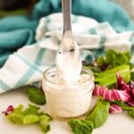 Creamy Donkey Sauce in a jar with a spoon.