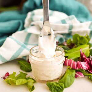 Creamy Donkey Sauce in a jar with a spoon.