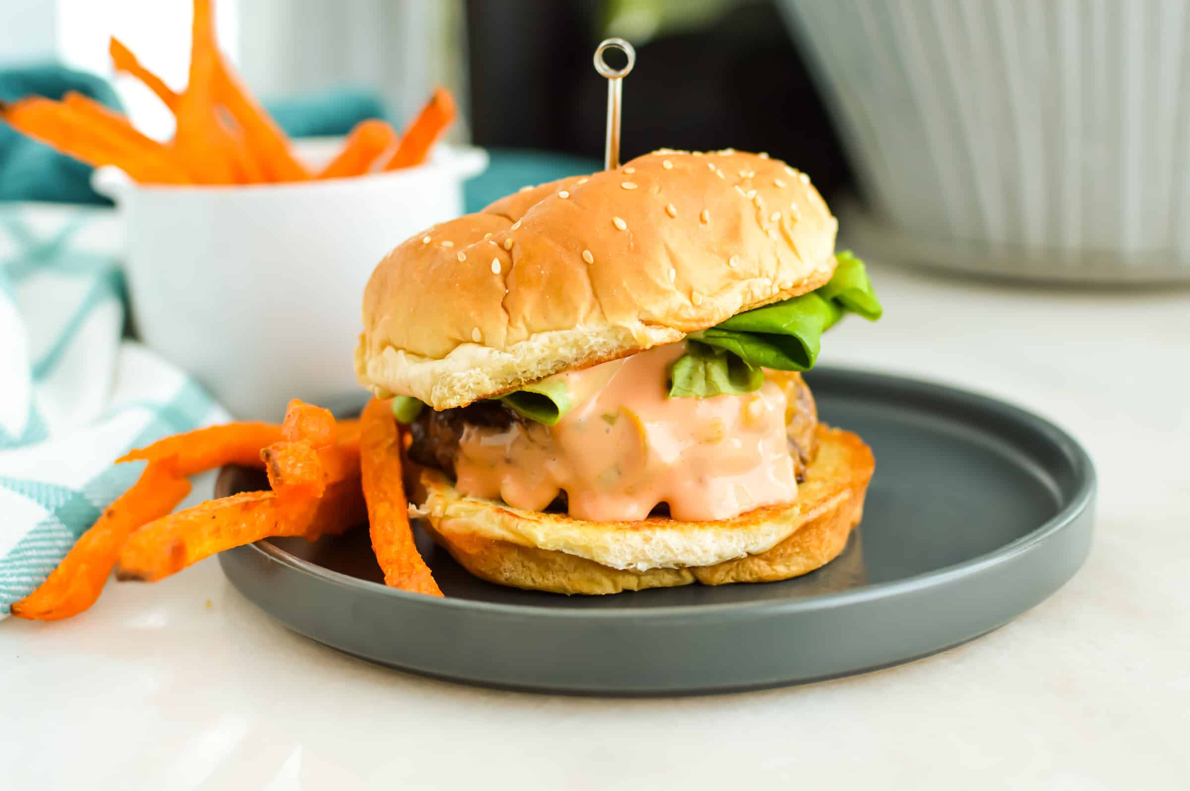 Hamburger with burger sauce and fries.