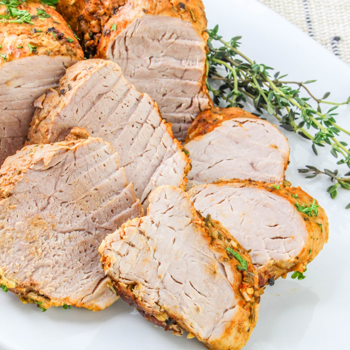 Close up of cast iron Dutch Oven Pork Tenderloin on a plate.