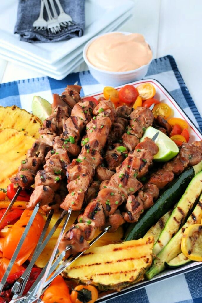 Platter of Grilled Chicken Kabobs with grilled vegetables and pineapple.