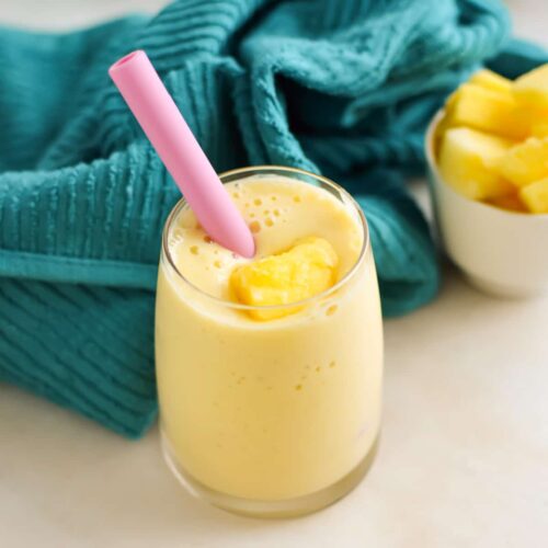 Pineapple smoothie in a glass with mango.