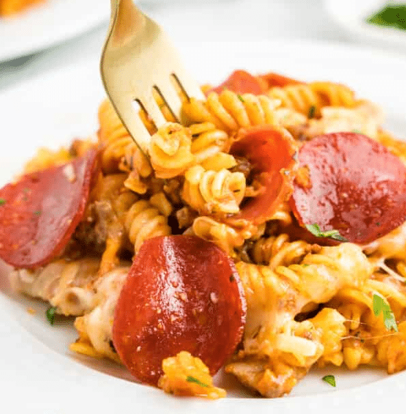 Pizza casserole on a plate with a fork.