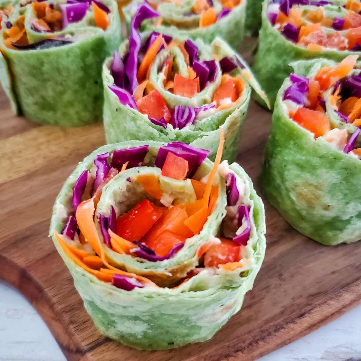 Close up of Hummus Rollups on a cutting board.