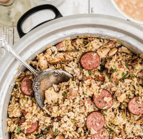 Top down image: pot of jambalaya with a spoon.