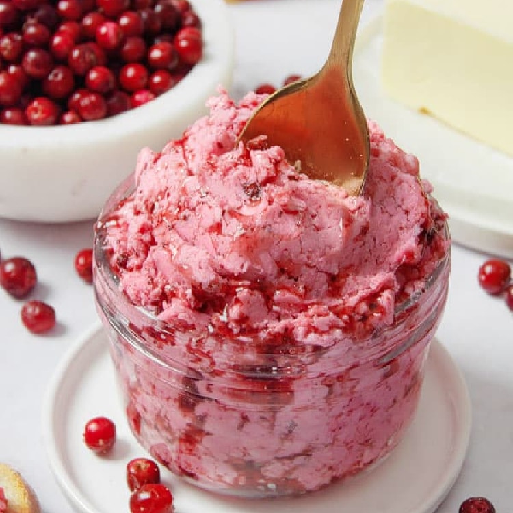 Lingonberry Butter in a small mason jar with a spoon.