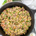 Recipe close up: Steak Fried Rice in a skillet with garlic, ginger, and green onions.