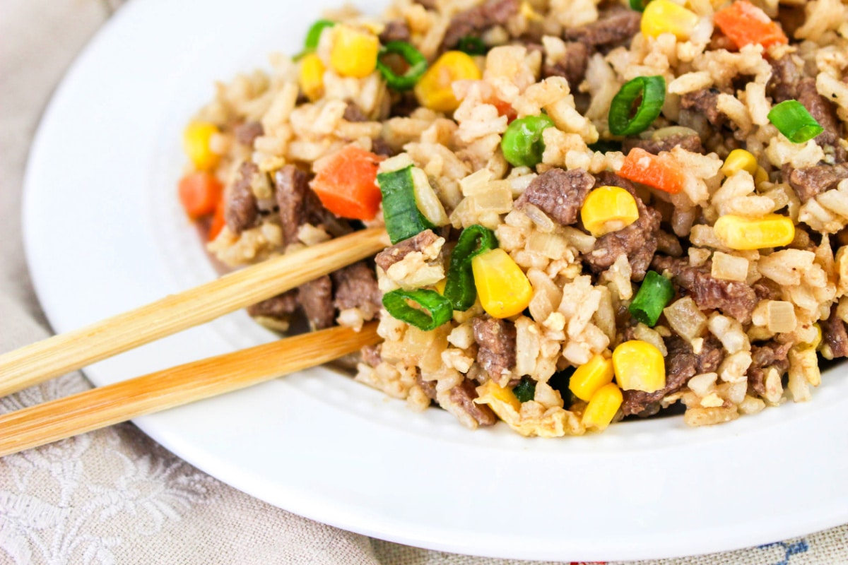 Close up of chopsticks with Steak Fried Rice Recipe.