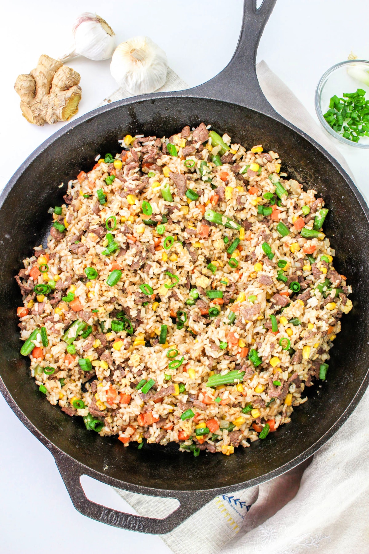Recipe: Steak Fried Rice in a skillet with garlic, ginger, and green onions.