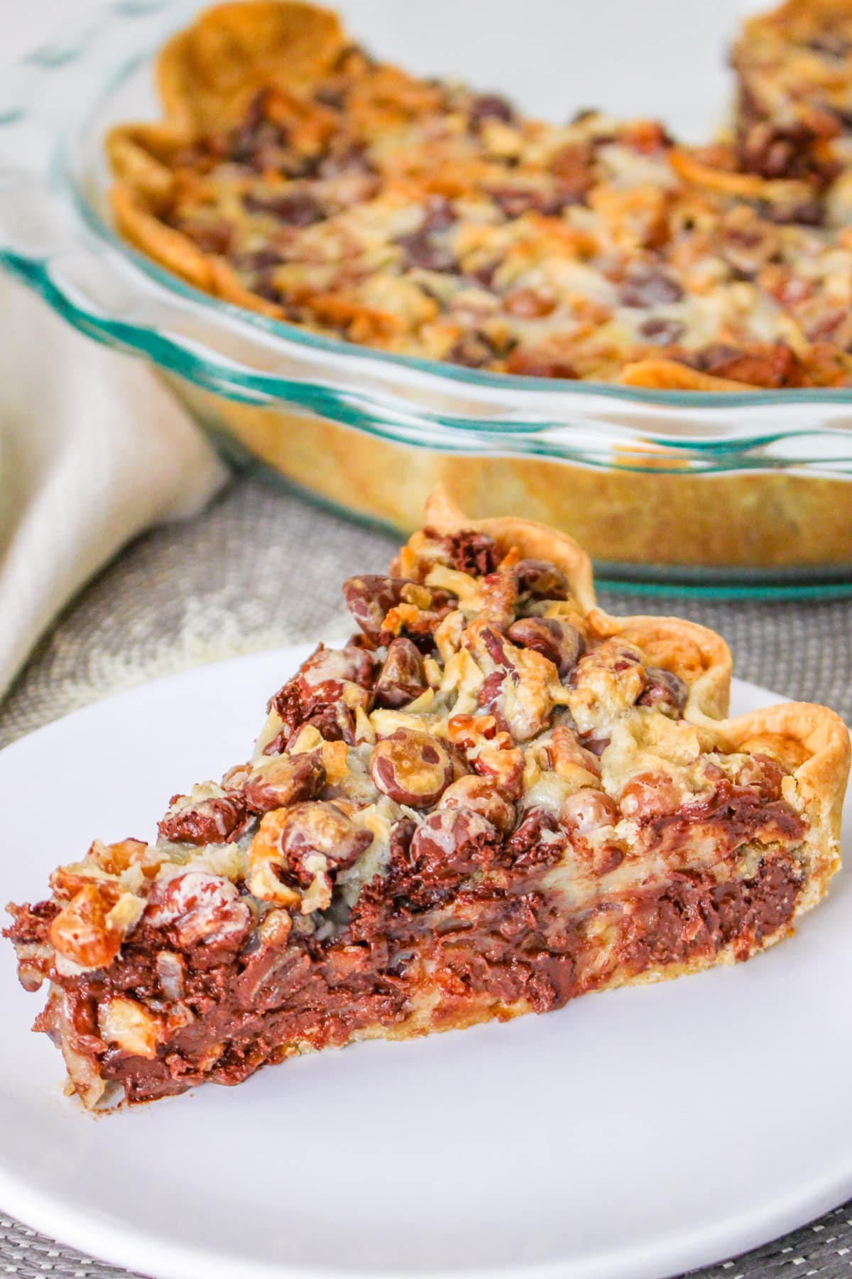 Slice of Texas Trash Pie on a plate with pie in the background.