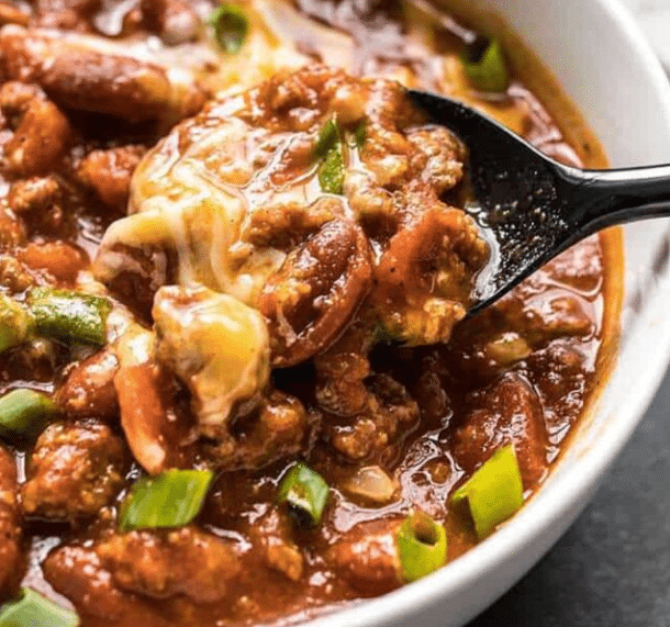 Close up of rice cooker chili on a spoon.
