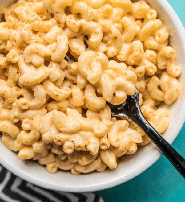 Top down view of creamy mac and cheese in a bowl with a fork.