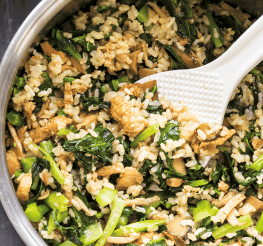 Top down view of rice with broccoli and mushrooms.